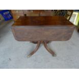 A Regency mahogany Pembroke style Supper Table with drop flaps and rosewood crossbanding, fitted