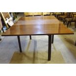 An early 19th Century mahogany Cottage Dining Table with oblong drop leaves on square supports. 5'