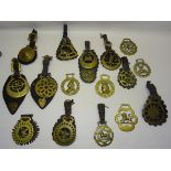 A number of Victorian and later Horse Brasses on leather straps.