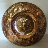 A Newlyn style copper circular Dish, the border decorated with a continuous band of fish. 15" (