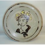 •Quentin Bell (1910-1996); a circular pottery Plate painted with the head of girl, painted in yellow