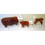 A Beswick model of a Hereford Cow, no. 1360, a Hereford calf, no. 1827c and another Hereford calf,