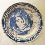 •Quentin Bell (1910-1996); a pottery Plate with raised border painted with a head in blue, green,