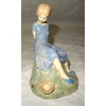 A pottery figure of Miss Muffet, the base inscribed "M Blyth". 5" (12 1/2cms) high (head repaired,