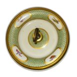 A 19th Century French porcelain circular shallow Bowl with a metal loop handle, the borders