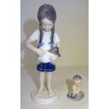 A Royal Copenhagen standing figure of a girl holding a puppy, no. 424. 7" (18cms) high and a small