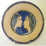 •Quentin Bell (1910-1996); a pottery Plate painted with two faces in shades of blue, within a