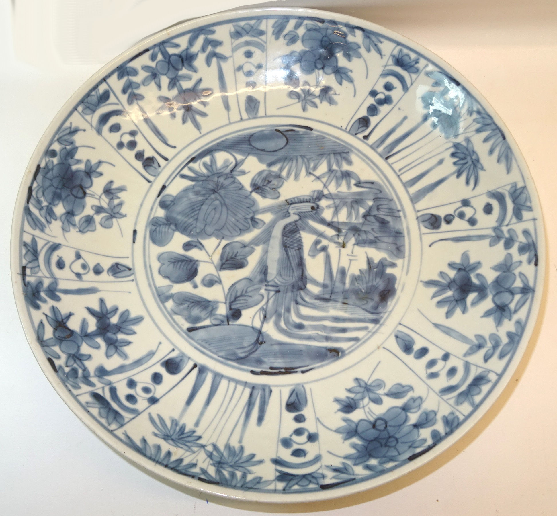 A 17th/18th century Chinese Provincial Dish decorated in blue and white with panels of flowers and