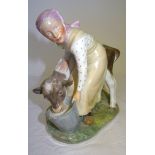 A Royal Copenhagen figure of a Dutch woman feeding a calf from a bucket, no. 779. 6" (15cms) high.