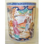 A Chinese cylindrical Mug decorated with panels of figures and foliage in famille rose and other