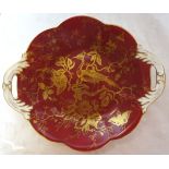 A Coalport two handled circular Dish, decorated with birds and flowers on a maroon ground.