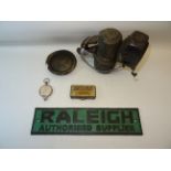 An old Cycle Lamp, a 'Raleigh Authorised Supplier' metal Sign and other items.