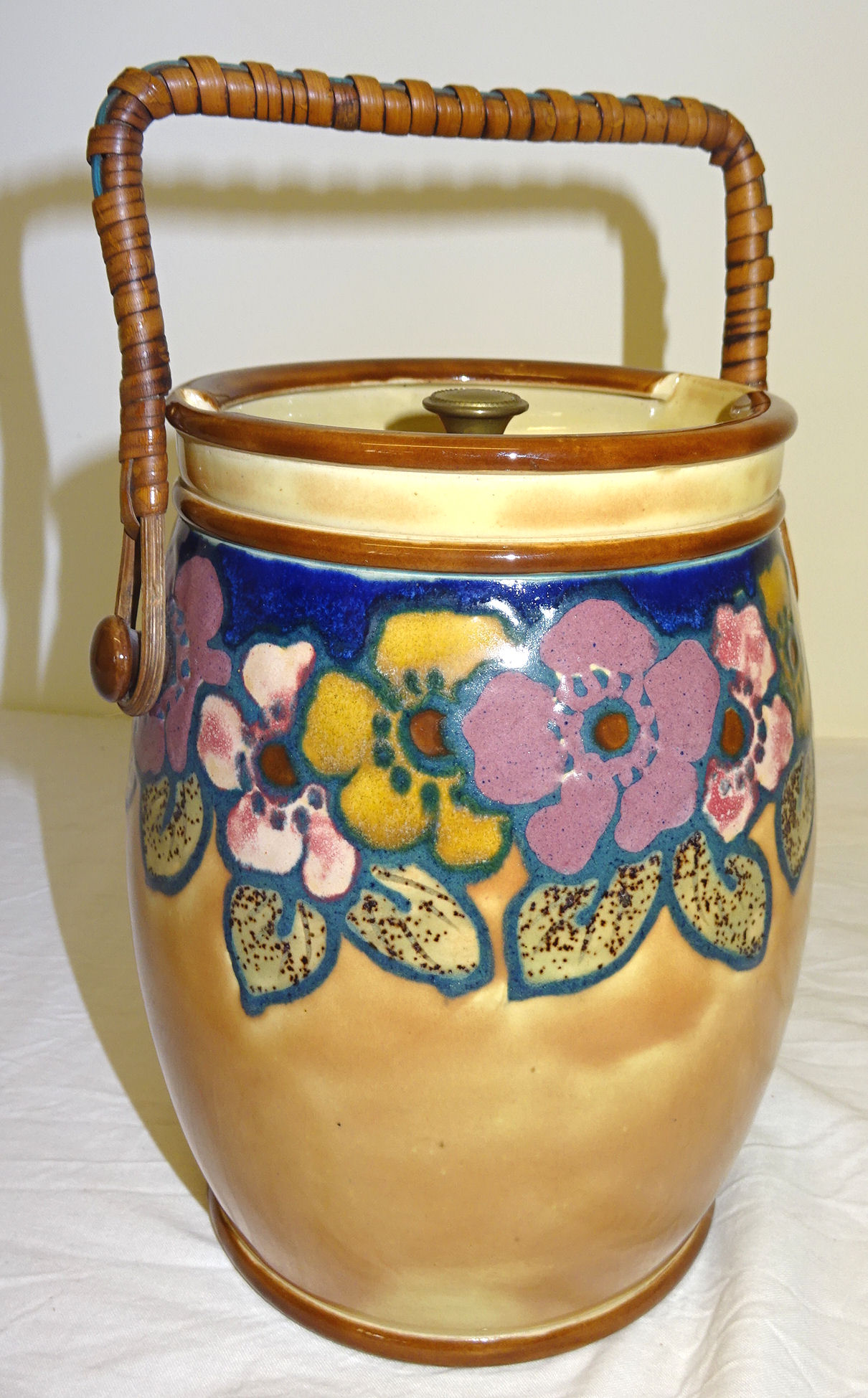 A Royal Doulton Biscuit Barrel and Cover designed by Vera Huggins decorated with stylised flowers