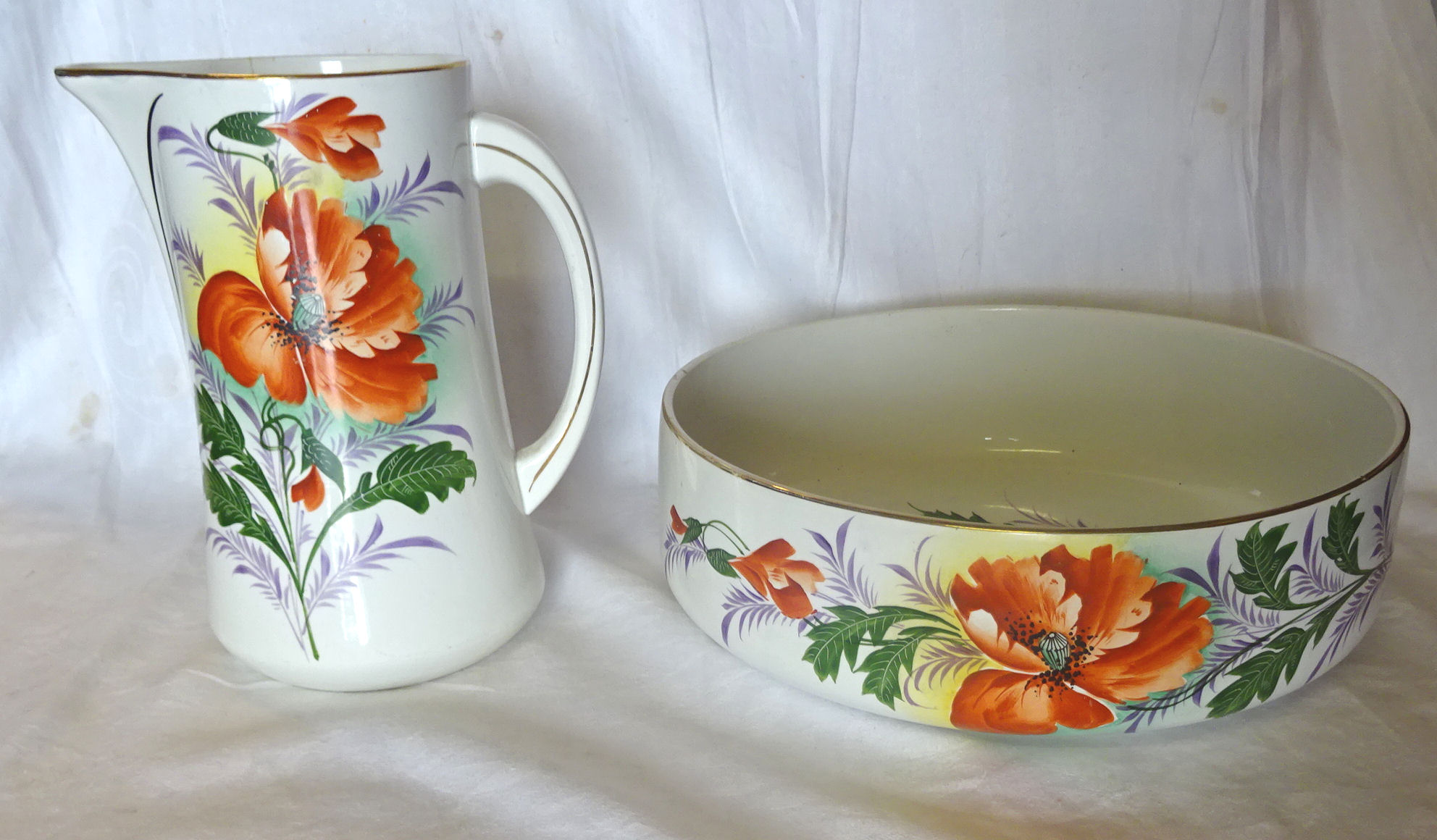 A French Ewer and Basin decorated with flower heads and leaves.