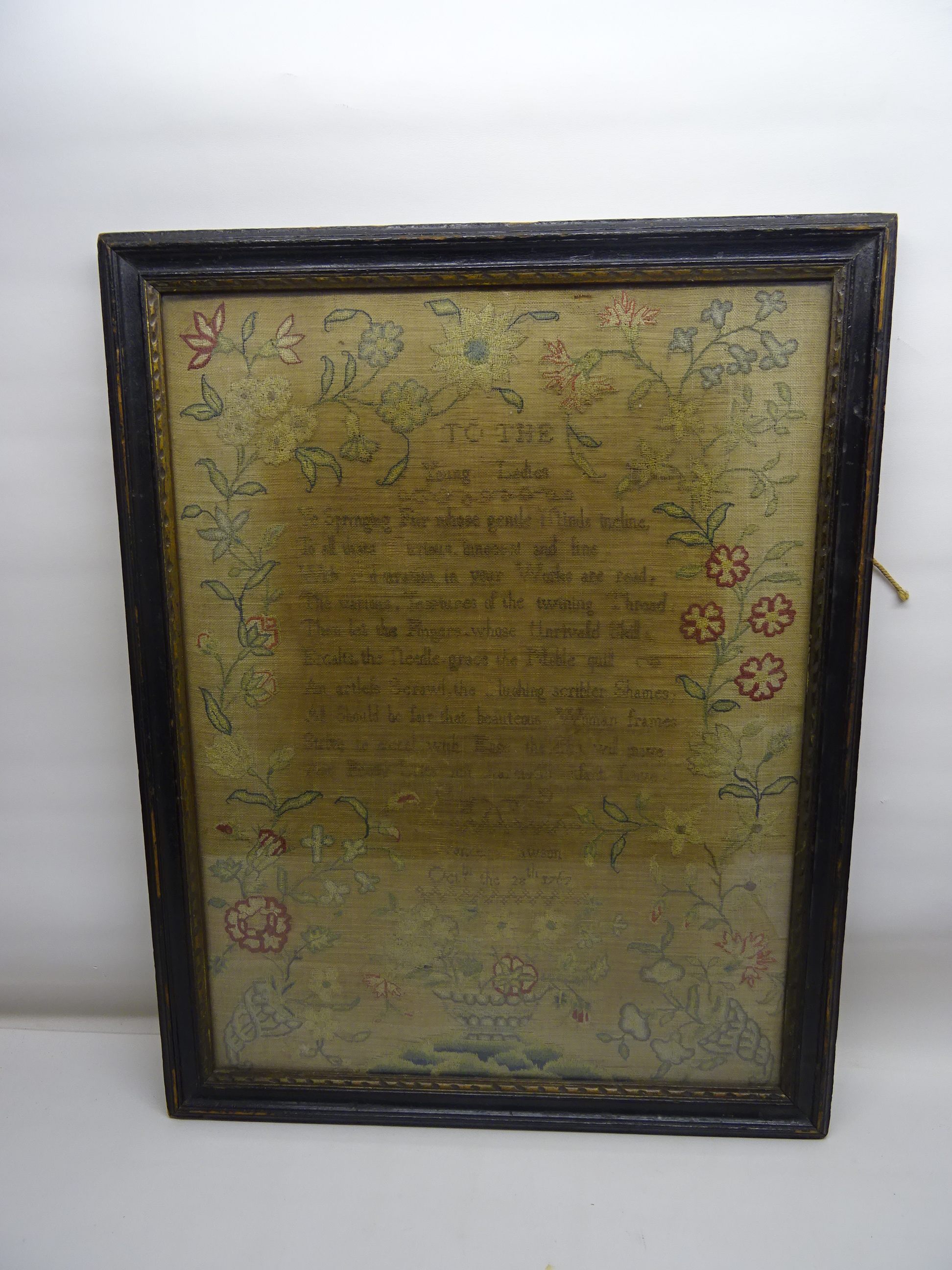 An 18th Century Needlework Sampler decorated with a verse inscribed "To the Young Ladies" within a