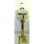 A brass Corinthian column Table Lamp with glass reservoir on a stepped square base and with