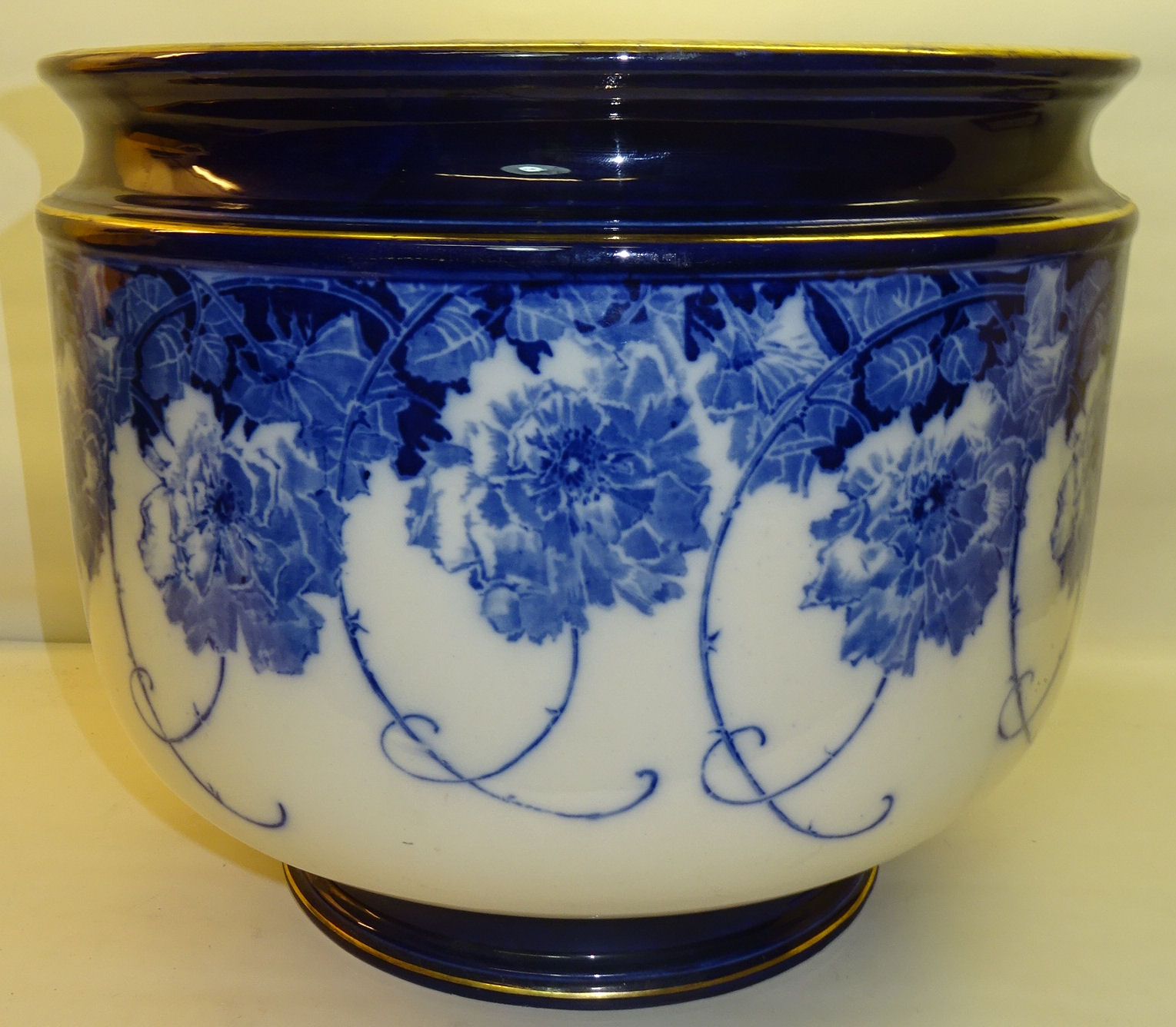 A large Royal Doulton Jardiniere decorated in blue and white with the briar rose pattern, 14" (