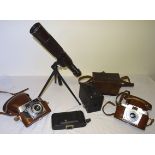 A Swallow Zoom Telescope on tripod stand, Brownie Box Camera, and three others.