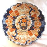 A Japanese Imari Plate decorated with panels of birds and flowers in orange, blue and gilt. 13" (