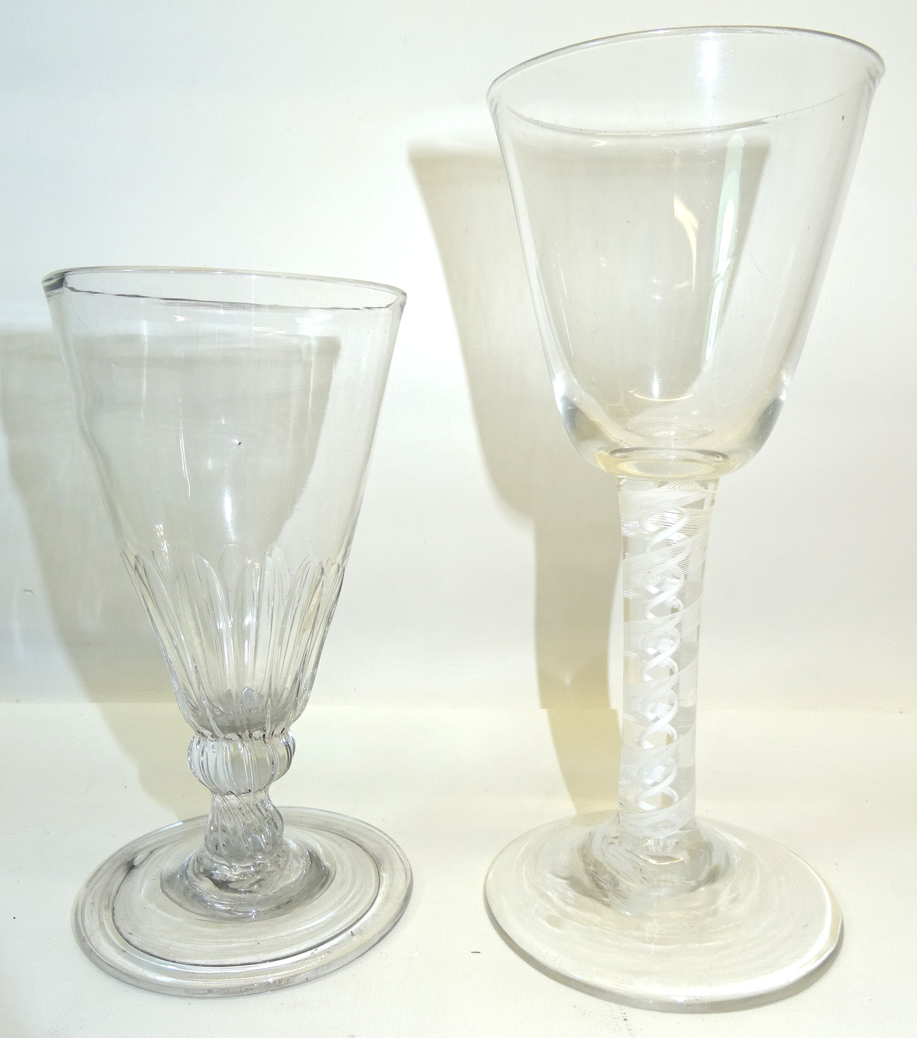 An early 19th Century Wine Glass with bucket shape bowl and cotton twist stem and a glass flute with