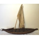 A tribal wooden Model of a Sailing Boat, possibly Pacific Islands, 26" (66cms) long.