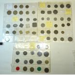 A number of plastic sheets containing a collection of Trade Tokens, 64 in total.