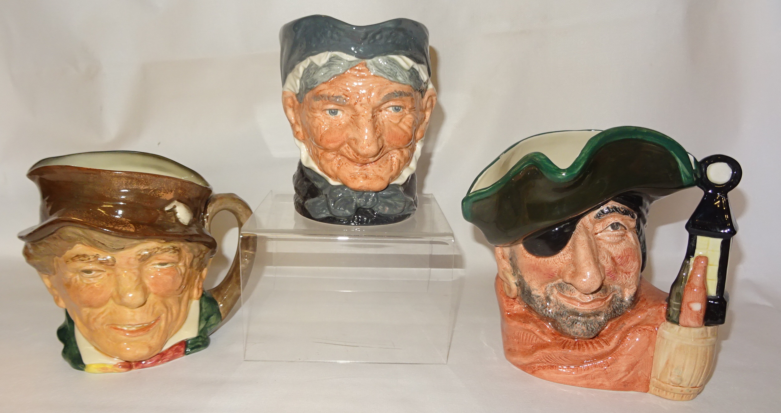 A Royal Doulton Character Jug 'Toothless Granny' D5251, large size, another 'Smuggler' D6616 and one