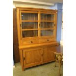 A modern kitchen cabinet with sliding doors.