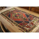 A small Persian design rug. 100 cm x 55 cm