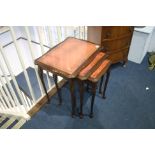 Reproduction mahogany nest of tables, with inset leather top.
