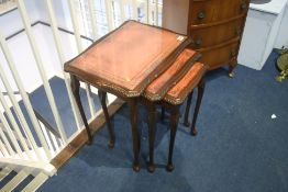 Reproduction mahogany nest of tables, with inset leather top.