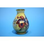 A small Moorcroft vase on a mottled yellow ground, decorated with 'Hibiscus', impressed mark.