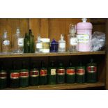 A large collection of green glass and other Chemist bottles.