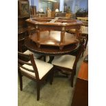 A circular table, four chairs and an octagonal table.