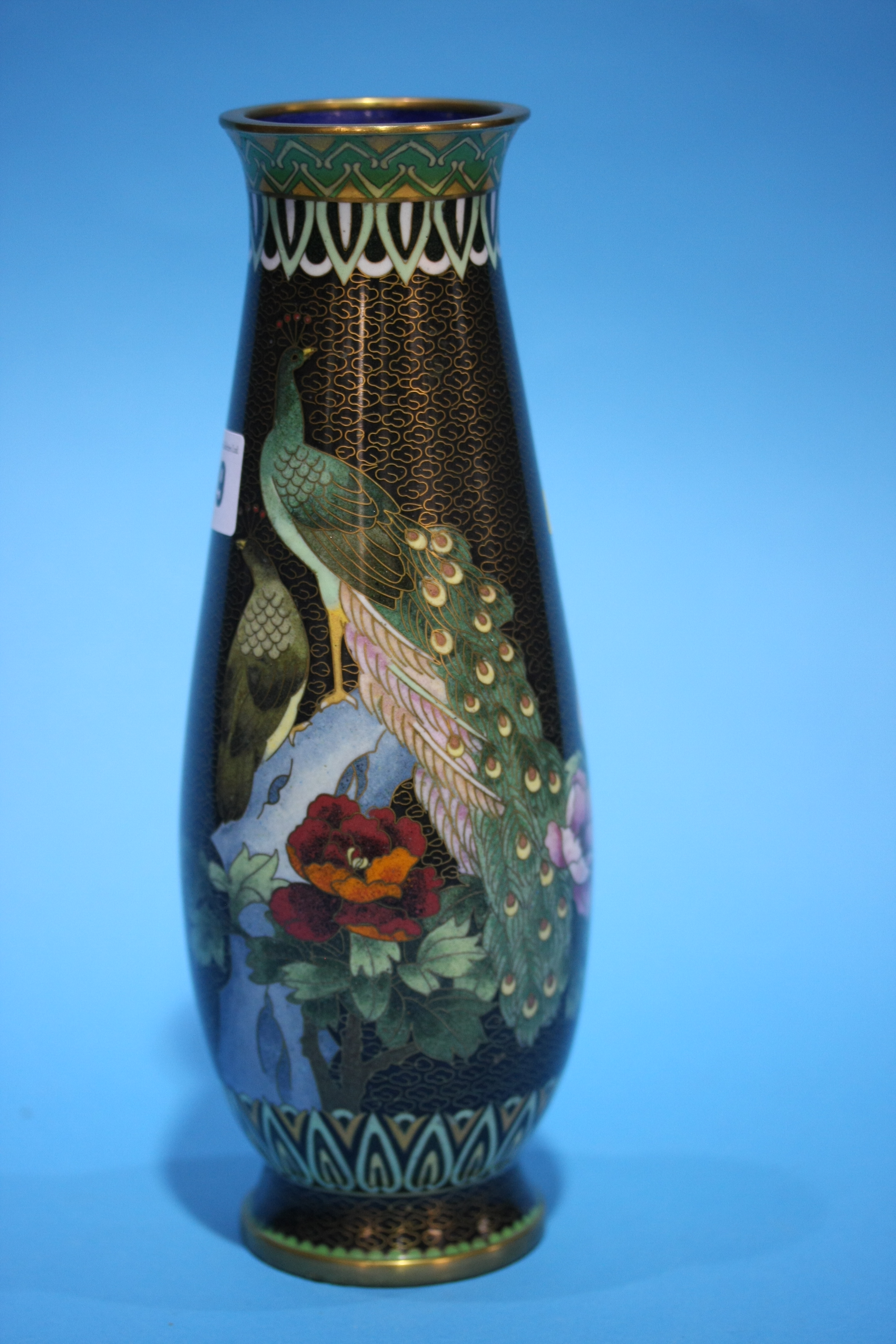 A tall tapering Cloissone vase, decorated with Peacocks. 25.5 cm high