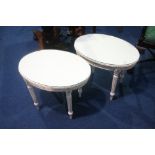 A pair of cream oval tables.