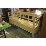 A long pine bench with raised back and rising seat. 187 cm long x 49 cm deep