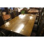 A Good quality oak side extending dining table, with a set of six oak dining chairs.