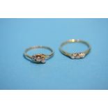 Two 18ct three stone diamond rings.