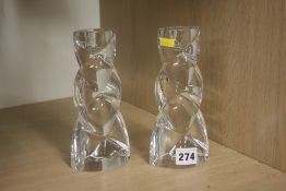 A pair of clear glass candlesticks.
