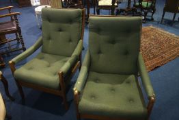 A pair of Guy Rogers style teak armchairs, with padded backs, arms and seats.