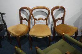 A set of three Victorian mahogany balloon back dining chairs.