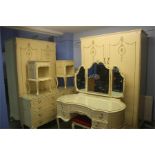 A Marie Antoinette cream bedroom suite comprising; two wardrobes, dressing table, chest of