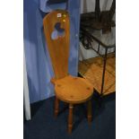 A small oak milking chair.