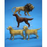 A Beswick lion and three dogs.