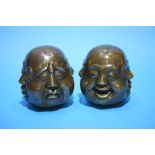 A pair of small Buddha's heads.