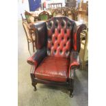 A Chesterfield oxblood leather high back armchair.
