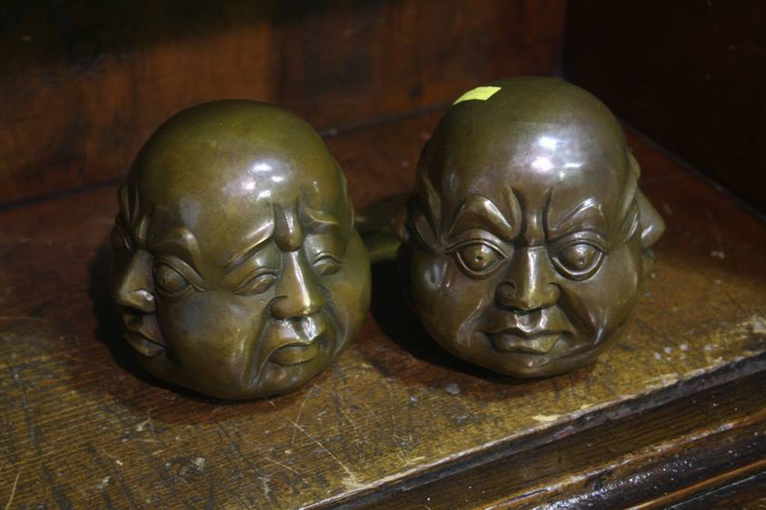 Pair of four faced Buddha heads