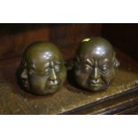 Pair of four faced Buddha heads