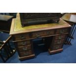 An Edwardian mahogany pedestal desk, with inset leather top and nine drawers, 106cm wide, 63cm deep